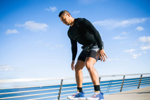Handsome mid adult man exercising on the city seaside.