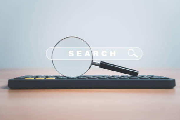 istock Magnifier glass on computer keyboard with search engine bar website on the table for searching information from internet , cloud computer by input optimization keyword concept. 1954884688