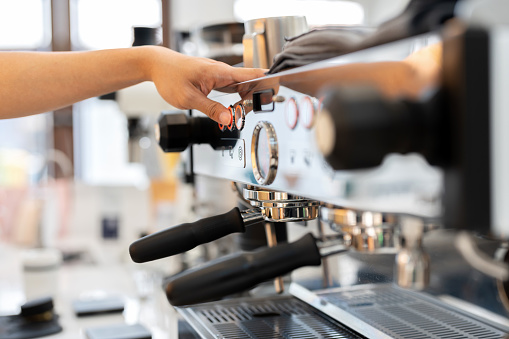 Modern coffee shop or cafe setting, the essence of morning rituals and the bustling energy of a small business. Mix spans the entire coffee experience from the machinery and preparation to the joyful moments of serving and enjoying the drink.