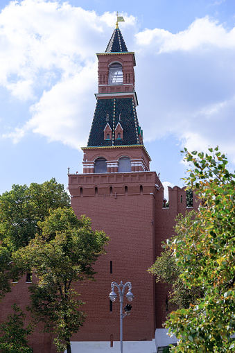 14.09.2023, Moscow, Moscow Kremlin, Russia. The alarm tower of the Moscow Kremlin is photographed against the background of a blue cloudy sky. Vertical photo.