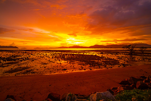 Beautiful colorful sunset or sunrise sky over sea with dramatic clouds nature environment background