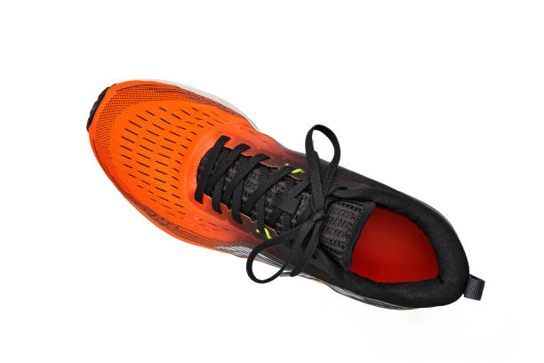 istock Left orange sneaker isolated on white background. Top view with copy space 1954940744