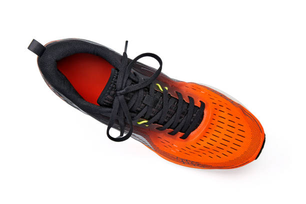 istock Right orange running shoe isolated on white background. Top view with copy space 1954940746