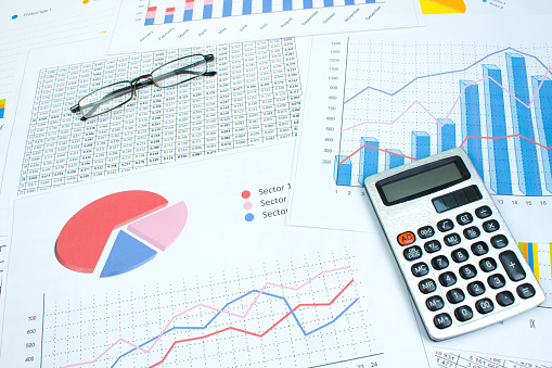 Financial printed paper charts, graphs and diagrams on the table