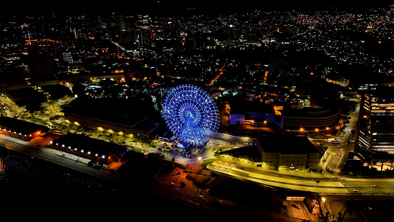 Cityscape of amusement park at downtown Rio de Janeiro Brazil. Night panoramic landscape of illuminated ferris wheel at downtown Rio de Janeiro Brazil. famous harbor zone tourism landmark of city.