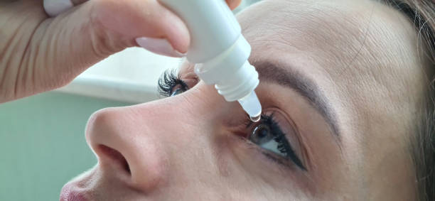 istock Woman face and dripping eye drops closeup 1954970052