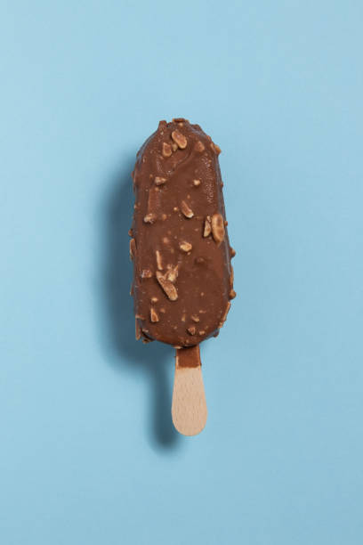 istock Ice cream covered with chocolate and almonds on a blue background 1954975273