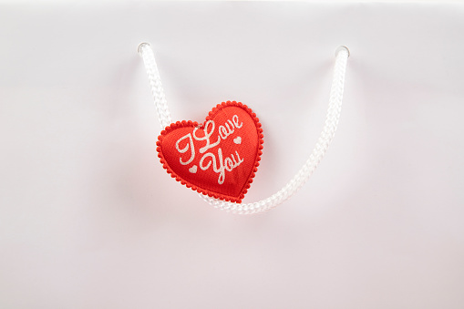 Red heart on handle of shopping bag