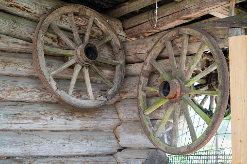 Taos, NM Style: Old Wood Wagon Wheel Against Wood Shinges.