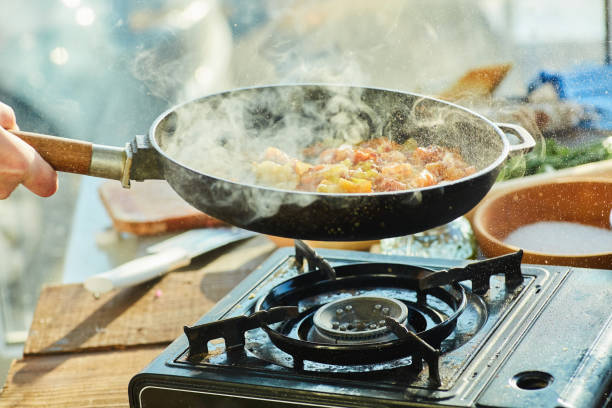 istock Step-by-step cooking process. Fry the chopped tomatoes together with onions in a preheated frying pan 1955022015