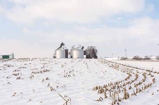 Rural illinois farmland and farm buildings in the snow.  Illinois, USA.