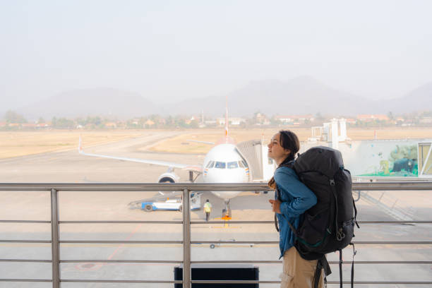 istock Woman walking in the airport with backpack 1955079974