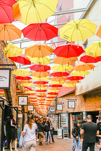 London, UK, 29 August 2023: The colourful umbrella alley in Camden stables market