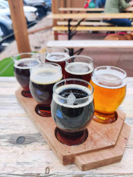 istock Beer samples on beer garden outside restaurant table drink background texture close up photo with copy space. Biergarten, brewery, pub, bar or taproom. 1955145276