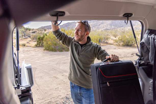 istock Departure Preparations: Loading Baggage into the Car Trunk at the Rental House 1955179862