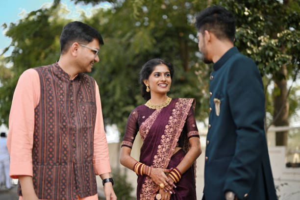 istock Sister and her brothers engaged in lively interaction while dressed in traditional attire 1955194772