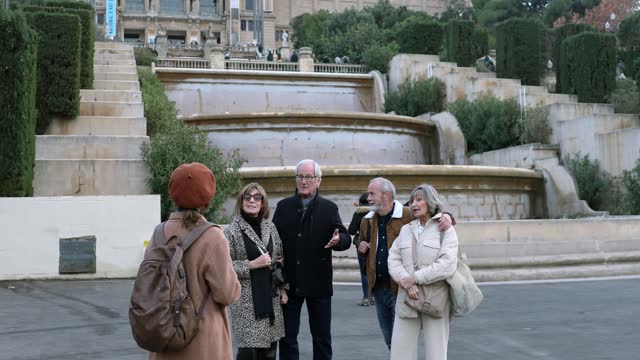 Senior friends with a tour guide at the city
