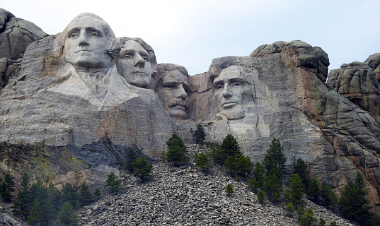 Mount Rushmore National Monument in South Dakota with carvings of George Washington, Thomas Jefferson, Theodore Rosevelt, and Abraham Lincoln a symbol of freedom and patriotism.