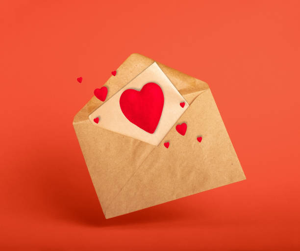 istock Vintage envolope and red hearts on red background. 1955272206