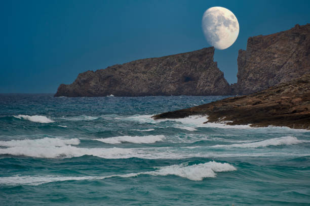 istock Moon rising between the cliffs of a Mediterranean beach 1955293651