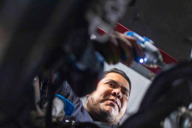 istock Portrait of mechanic examining engine 1955343646
