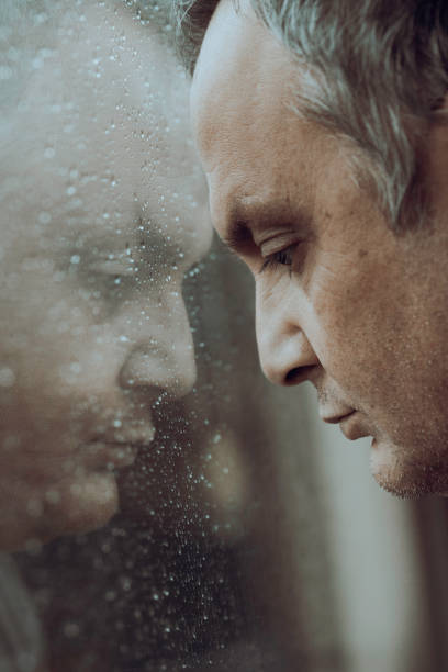 istock Pensive Man Looking out of Window 1955356278