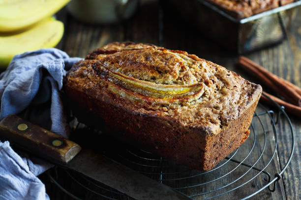 istock Fresh Banana Bread Cooling on Bakers Rack with Ingredients 1955377349
