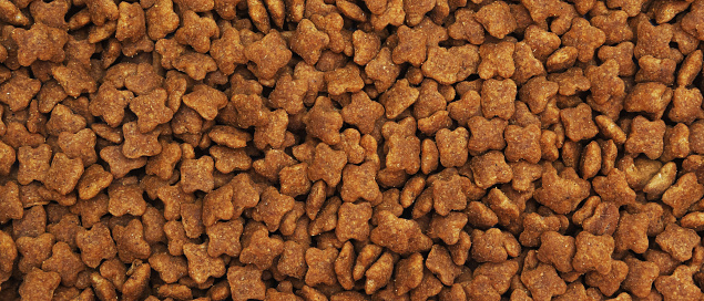 Dried food for cats or dogs in the form of a background. Panorama.