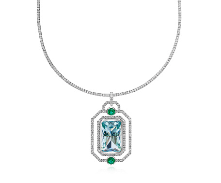 An exquisite pendant necklace featuring a central diamond, emerald accents, and a delicate chain, showcased against a pristine white backdrop.