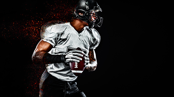 An American Football player and running back in full tackle football pads is ready to play. Image taken in Utah, USA.