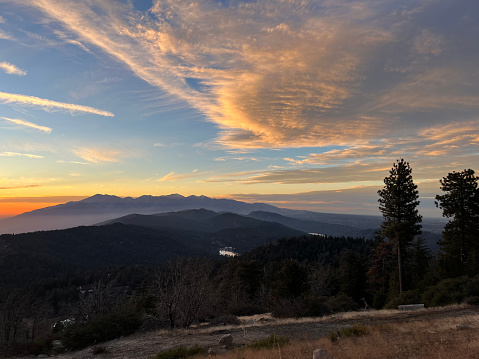 Sunset over Mount Baldy with clouds and trees