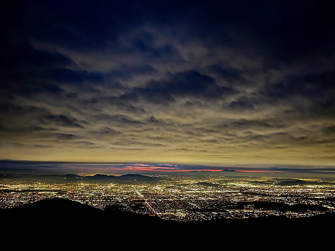 View of the city lights of San bernardino, Inland Empire during a sunset with clouds at night