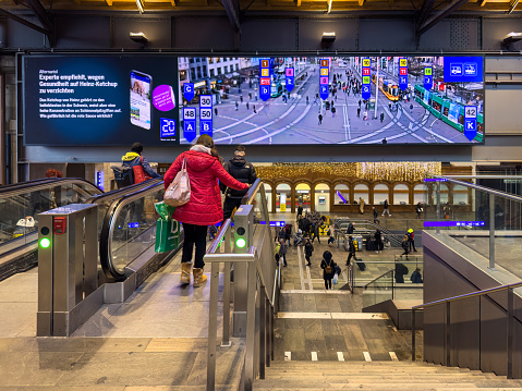 Basel, Switzerland - December 21, 2023: A screen inside the Basel train station showing the tram stop and tram departures