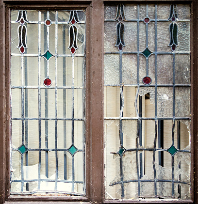 Part of a vandalised Art Nouveau window in a derelict public house in Ipswich, Suffolk, Eastern England.