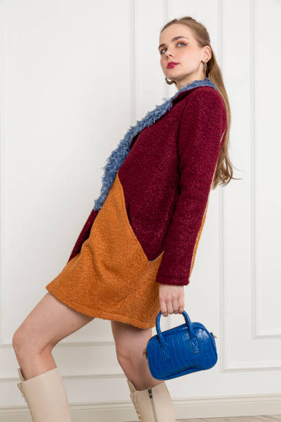 istock Blonde young woman wearing multi colored jacket. 1955478209