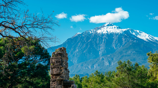 Mount Tahtali with its snowy peak surrounded by historical cities in Antalya. Taken from the historical location of Phaselisin