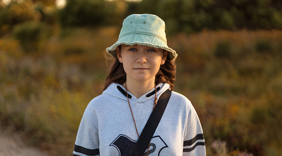 Teenager girl smiling happy while hiking in nature in the forest.