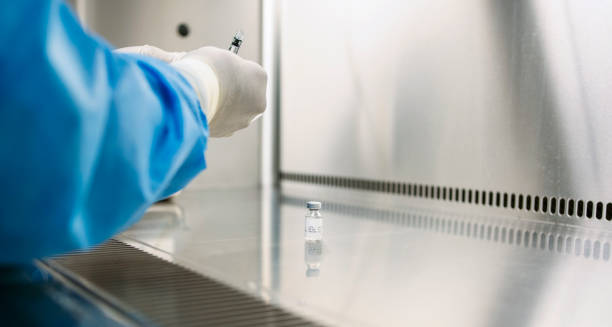 istock Pharmacist working with medication behind protective glass in a laboratory 1955529763