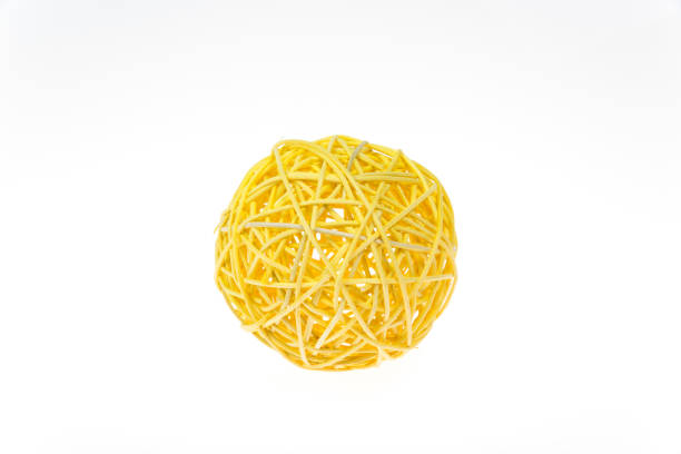 Decorative woven wicker or rattan yellow ball isolated on white.