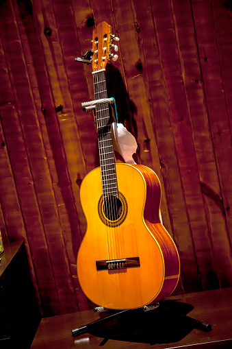 Classic spanish guitar  near of a wood wall