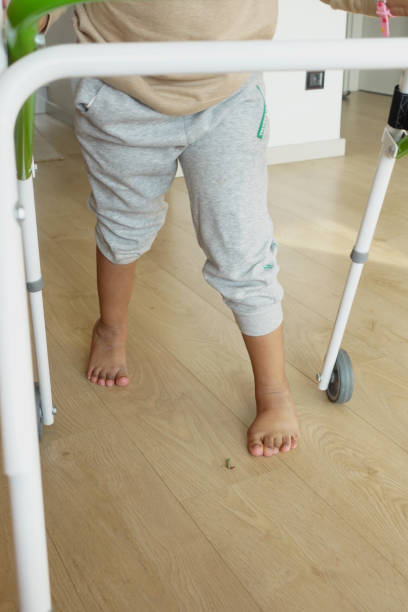 istock child with walking frame and knee orthosis at home 1955567025