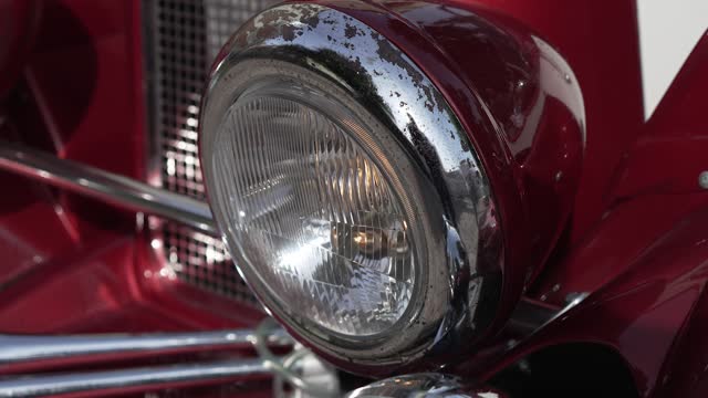 Old american car headlight with rust elements. Close up shiny light and front side of vintage auto