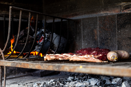 Argentinian meat roasting on the grill. Making a traditional barbecue called Asado in Argentina.