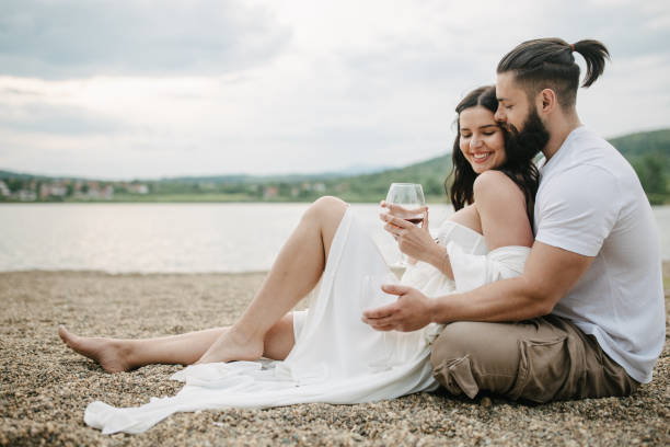 istock Couple sitting by the lake 1955650822