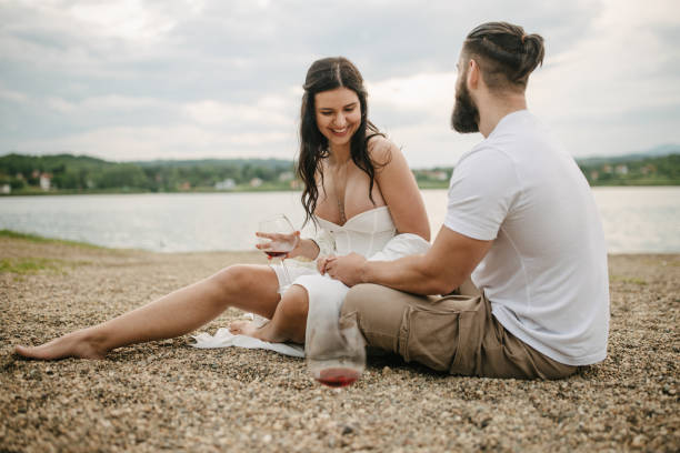 istock Couple sitting by the lake 1955650864