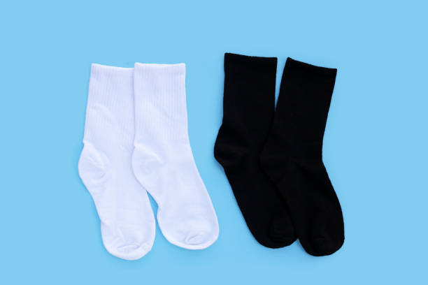 istock White and black socks on blue background. 1955651416