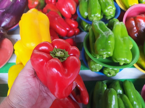 Sweet long peppers in basket. Red yellow and orange sweet long peepers.