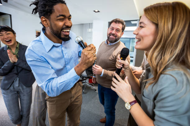 istock Colleagues having karaoke party in the office 1955656151