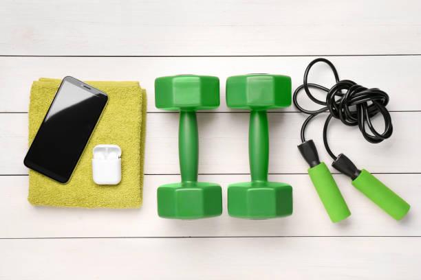 istock Flat lay composition with dumbbells on white wooden table 1955659938