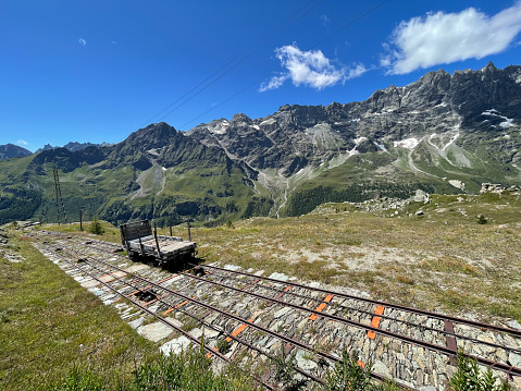 Mountain range with an abandoned railway track in summer, Aosta Valley, Italy